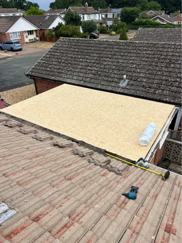 During replacement - old flat roof covering removed and new timber roof deck installed. By Norfolk Exterior Solutions.